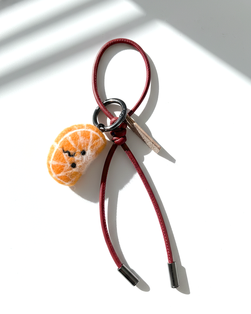 Needle felt orange slice keychain with red leather loop, handmade wool citrus charm