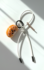 Handmade needle-felted orange slice keychain with white leather loop and metal ring