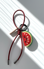 Wool felt watermelon keychain with red leather loop, handcrafted fruit bag charm accessory